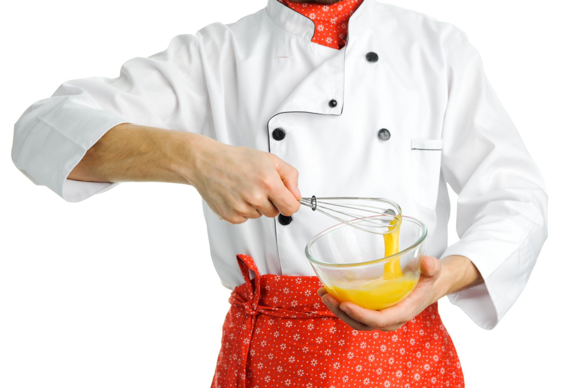 Chef preparing a colorful dish in a modern kitchen